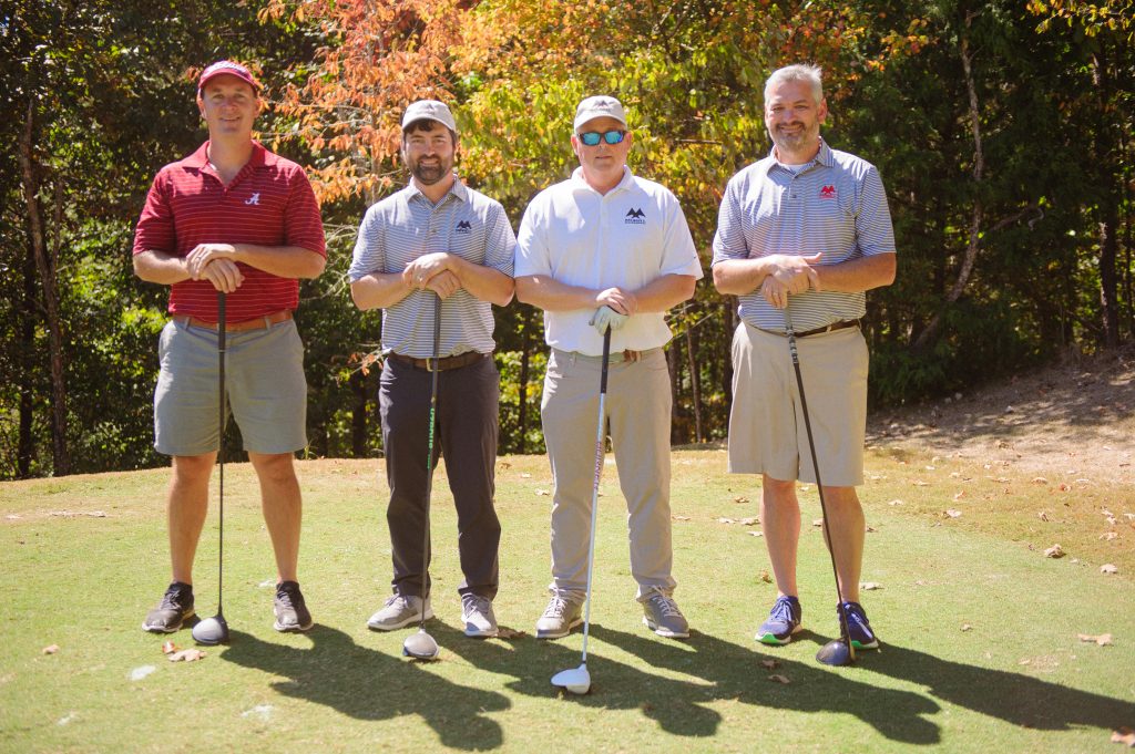 Morell Team of 4 guys stand on golf course